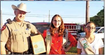 Trooper Jason Duncan takes a moment to stop by and get his cookies from Melody Lewis and Lily Thomas. Melinda Foster photo