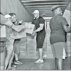 The Marlin Democrat<br />          Houston Texan defensive end J.J. Watt pictured centered off loads a semi truck of donation to one of four different Hurricane Harvey relief stations. Watt along with other fellow teammates has now raised more than $18.5 million dollars in donations for the victims of Harvey.