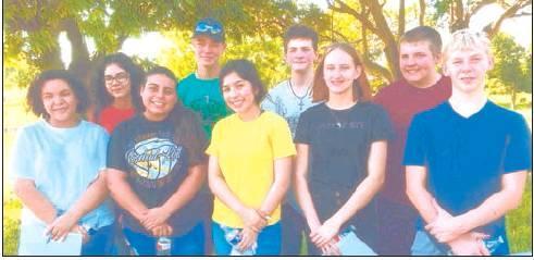 Bottom, from left, Aliyah Walker, Kaitlyn Alonso, Elvia Ibarra, Ashlie Gary, Hunter Sullivan; top row, from left, Emma Ibarra, Hunter Rogers, Ethan Sampson, and Ethan Krieger along with their sponsor Amy Krieger, Band Director David Vuteto and Camber Commeaux placed flags on the graves at the Clover Hill Cemetery.