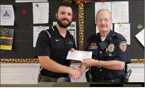 Molly Wilson | The Rosebud News Tyler Tuerck, Operations Manager of Lone Star Distribution Center, appreciatively gives the check to Rosebud Police Department’s Chief Hensley.