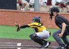 Easton Green reaches for a pitch behind the batter during the JV Cougar Classic played last week at RLHS. Easton Green reaches for a pitch behind the batter during the JV Cougar Classic played last week at RLHS.