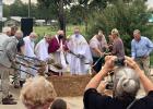 Father Darrell and parishioners participating in the groundbreaking.