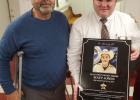 Deputy Eric Correa accepted an award from Reisel Mayor Kevin Hogg.
