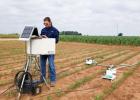  Walker Crane, a member of Nithya Rajan’s team, measures nitrous oxide measurements from a young sorghum field. (Texas A&M AgriLife photo)